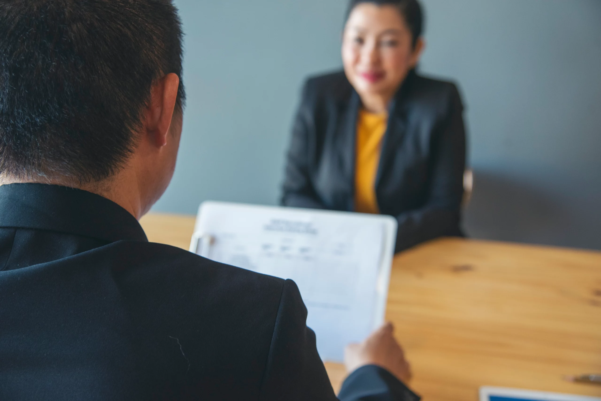 Business professional reviewing employment immigration documents for PERM labor certification requirements