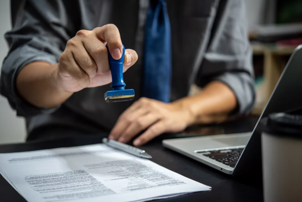 Businessman stamping approved on employment certification documents for PERM labor certification process