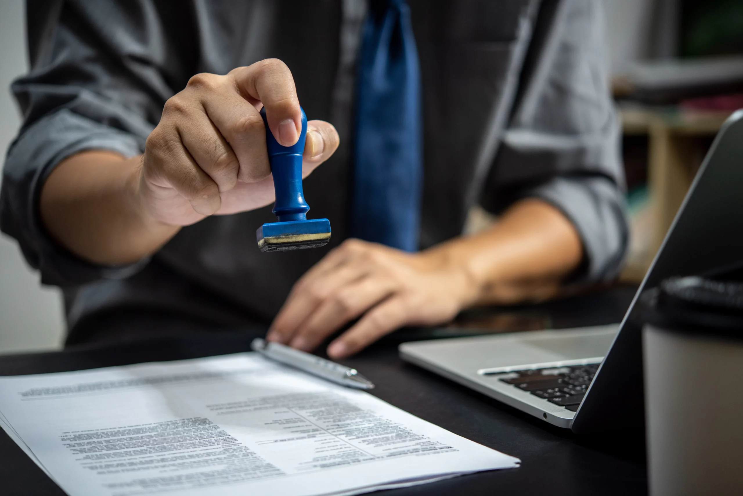 Businessman stamping approved on employment certification documents for PERM labor certification process